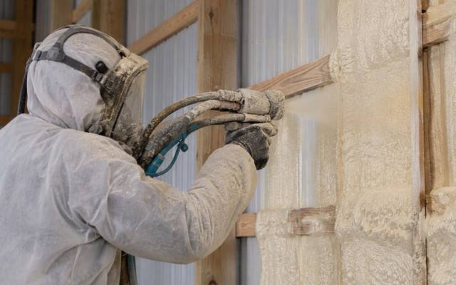 Close view of closed cell foam going onto a steel wall