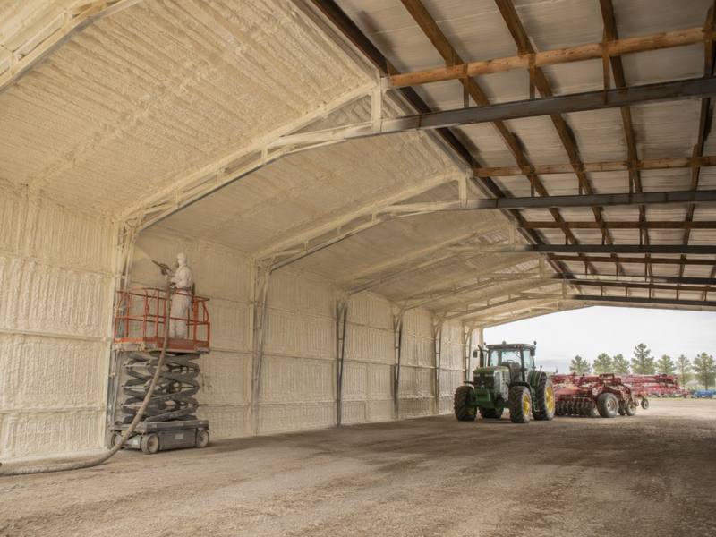 Open farm building with spray foam on the walls and roof
